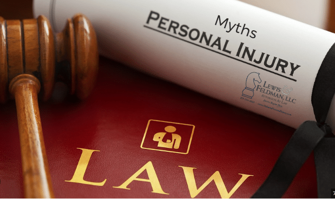 Gavel and law book next to a rolled document labeled "Myths Personal Injury," featuring a law firm's logo.
