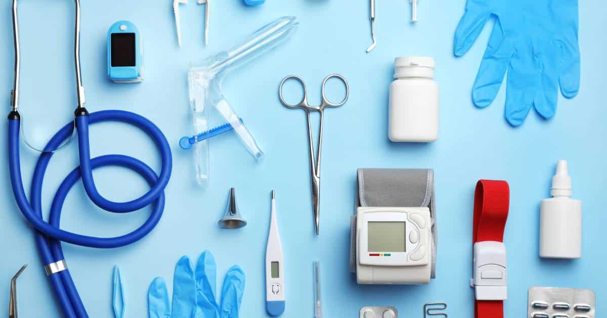 Medical equipment and supplies including a stethoscope, gloves, thermometer, pill bottle, syringe, blood pressure monitor, and various tools arranged on a blue background.
