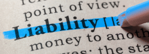The word "Liability" is highlighted in blue on a printed dictionary page.