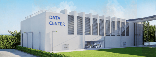 A large white building labeled "Data Center" with vertical vents on the wall, surrounded by greenery and a clear sky.